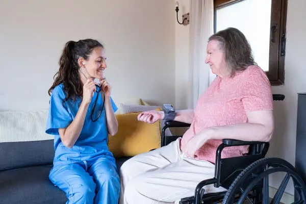 Qualified nurse checking an older person's health at home