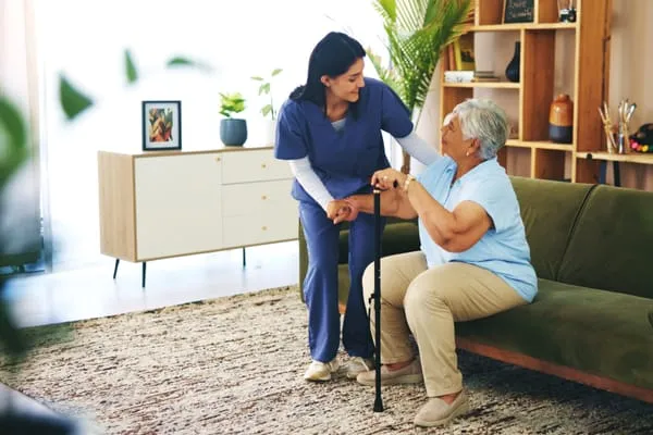 Carer offering supportive assistance to an older person