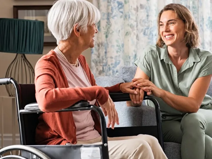 Carer and older person sharing a warm, joyful moment together