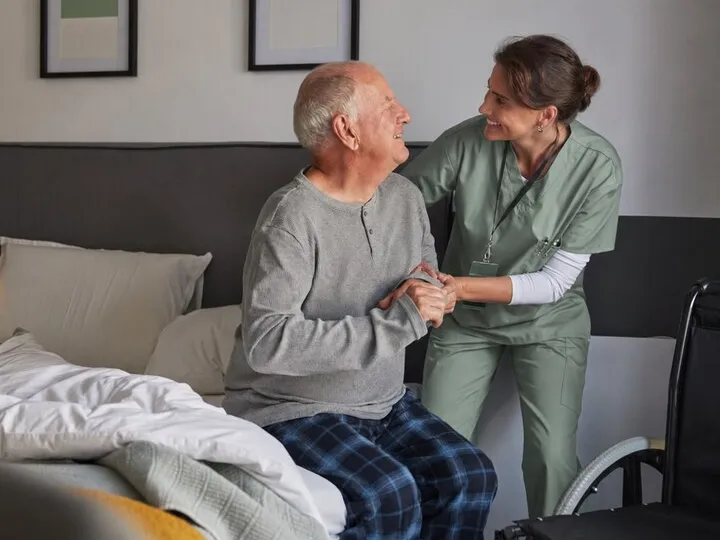 A carer providing in-home health support to an older person
