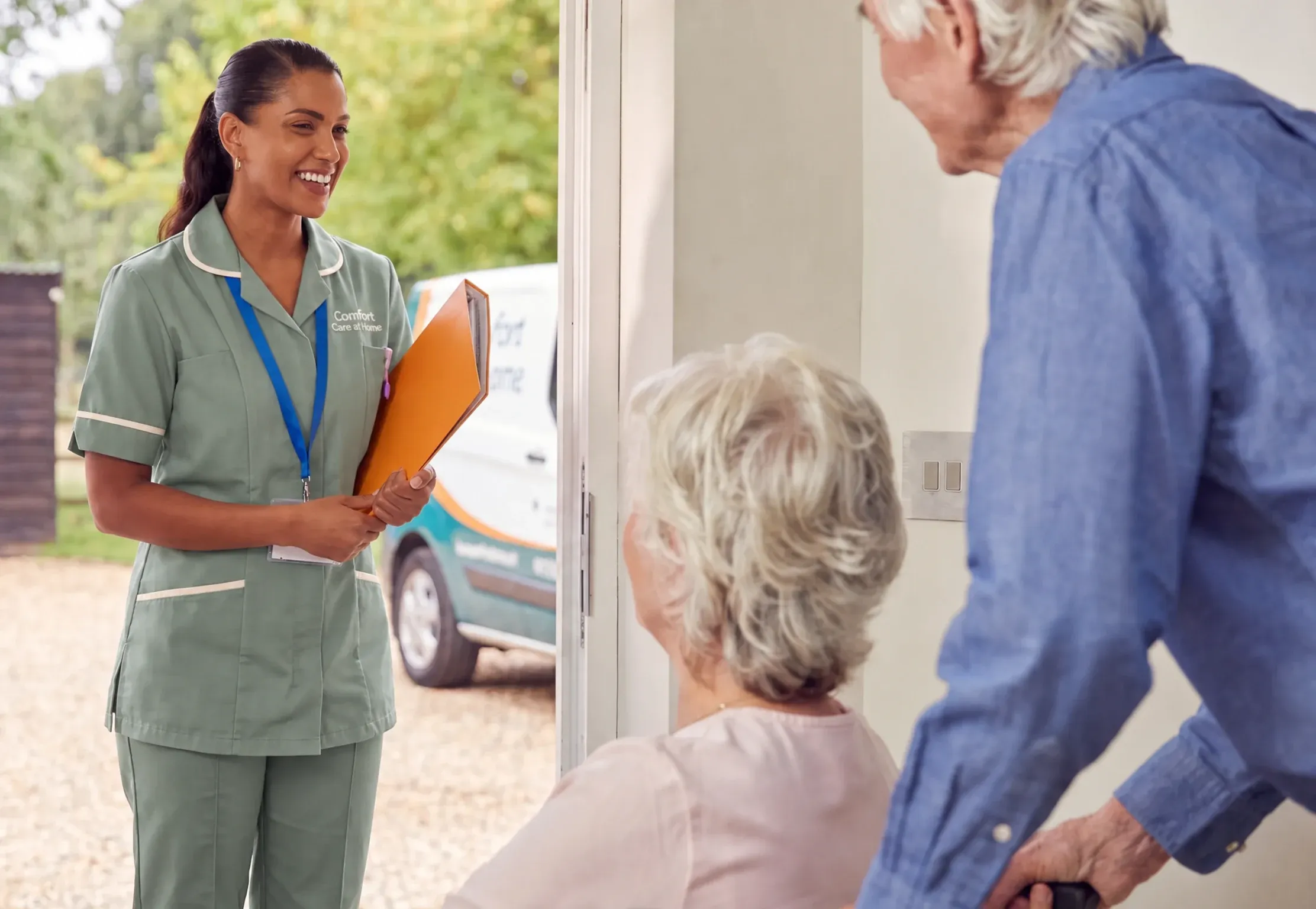 A carer warmly supporting an older person at home